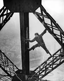 Repainted: Worker painting the Eiffel Tower. Working ?