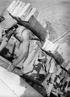 Ladders: Workers carry bricks, 1939