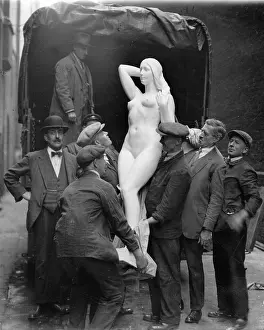 18000: Workers lifting a sculpture of a woman from a lorry