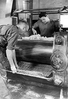 Buna: Workers at a machine producing synthetic rubber