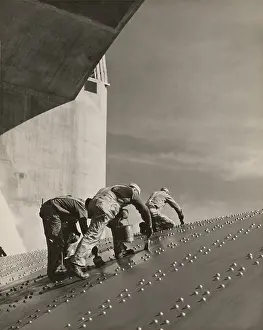 Slanted: Three workers painting on a slanted wall ?