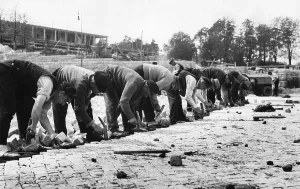 Cobblestones: Workers paving road, 1936
