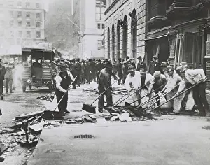 Anarchism: Workers sweeping up rubble and broken glass following