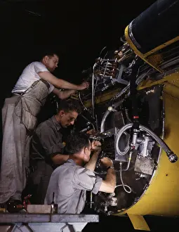Accuracy: Workers wiring assemblies on the fire wall