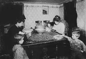 Comfortably: Working family, caption: Picking nuts in ?