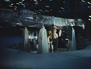 Bombers: Working on wing of Consolidated Liberator