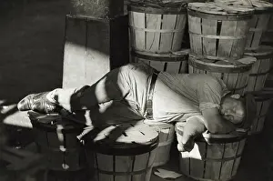 Bushel: Workman catching a nap at the Baltimore fish market