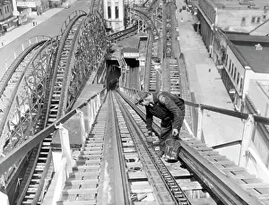 Coaster: A workman greases up the tracks of the Cyclone ?