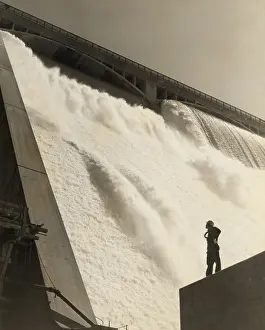 Powerhouse: A workman inspecting the Grand Coulee Dam from
