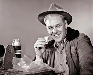 Thermos: Workman on Lunch Break Eating Sandwich