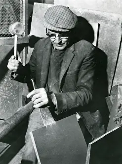 Splitting: Workman splitting a slate at a quarry in North Wales