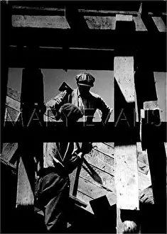 Roofer: Workmen roofing a house in the 1930s