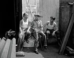 Obey: Three workmen sitting under no smoking sign smoking