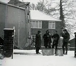 Cuppa: Four workmen stop for a cup of tea on a snowy day
