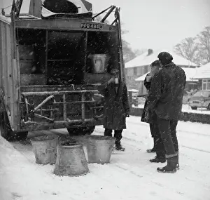 Cuppa: Three workmen stop for a cup of tea on a snowy day