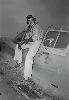 Cockpit: World War II fighter pilot posing on aircraft, 1943
