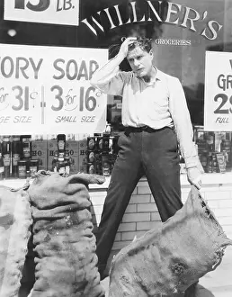 Overworked: Worried man holding sack