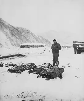 East Asia: A wounded chaplain reads a memorial service over