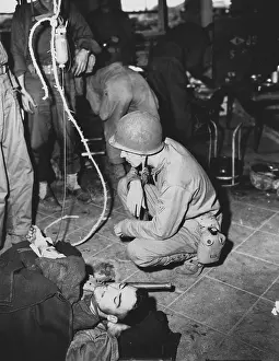 Corpsman: A wounded Marine is given whole blood by a medic
