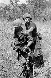 Stocktrek Images: A wounded soldier is led to a medevac helicopter