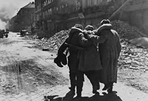 Khaldei: Wounded Soviet (Russian) soldier helped by two