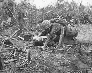 Lcgr1311: A wounded U.S. Marine takes is given water while