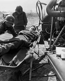 Medical Care: Wounded U.S. soldier lifted onto a helicopter for