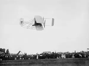 Firsts: Wright Model A airplane flying above spectators