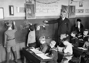 Supervises: Writing lesson in the school, 1930