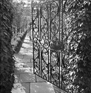 Colin Sherborne Collection: Wrought iron gate in a garden