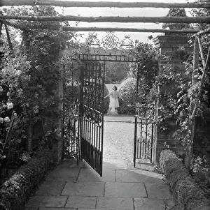 Colin Sherborne Collection: Wrought iron gate in a garden