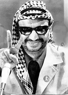 Flashes: Yasser Arafat flashes victory sign at the ?