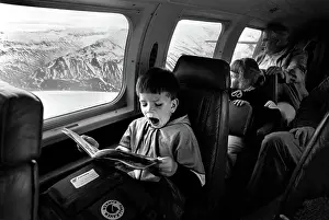 Yawn: Yawning boy reads comic during an internal flight in Iceland