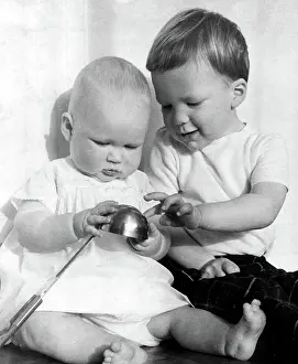Refection: Three year-old old boy explaining a reflection to his baby s