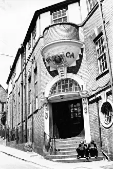 Comics: YMCA building with two boys on the steps
