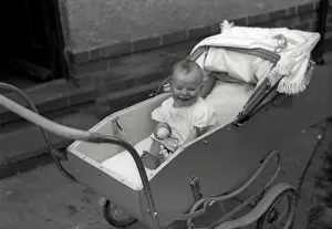 Nigel Sorrell: A young baby in a fine pram