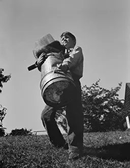 Donation: A young boy collects scrap for America's war