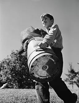 Donation: A young boy collects scrap for America's war