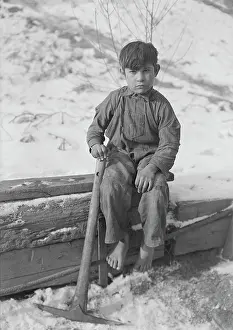 Old Fashion: A young boy digging coal from mine refuse