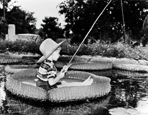 Skiff: Young Boy Floating On Lilly Pad