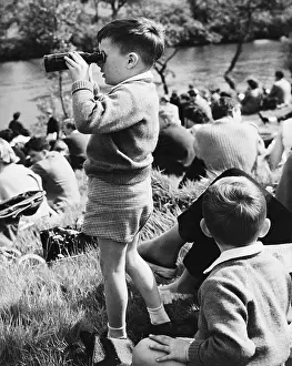 Peers: Young boy looking through binoculars - Chester, 1961