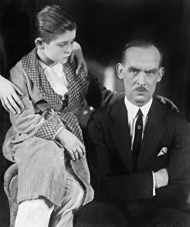 Displeasure: Young boy looking worried at his father