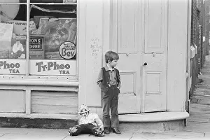 Bonfire: Young boy outside shop with a guy