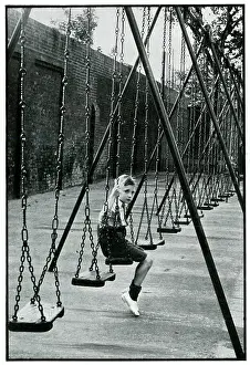 Phony: Young boy alone on a playground swing 1939