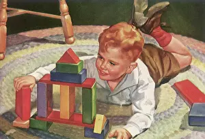 Plaything: Young Boy plays with Building Blocks