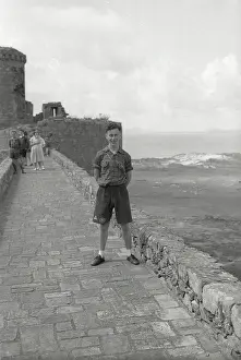 Harlech: Young boy standing on the ramparts of Harlech Castle