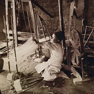 Unwinding: Young boy unwinding silk cocoons and reeling ?