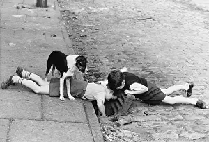 Drain: Two young boys peer down a drain, 1963