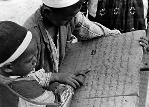 Schoolchild: Two young boys studying arabic letters