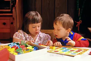 Net002: Young Brother and Older Sister Playing a Game